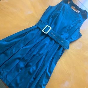 High collar, sleeveless pleated dress